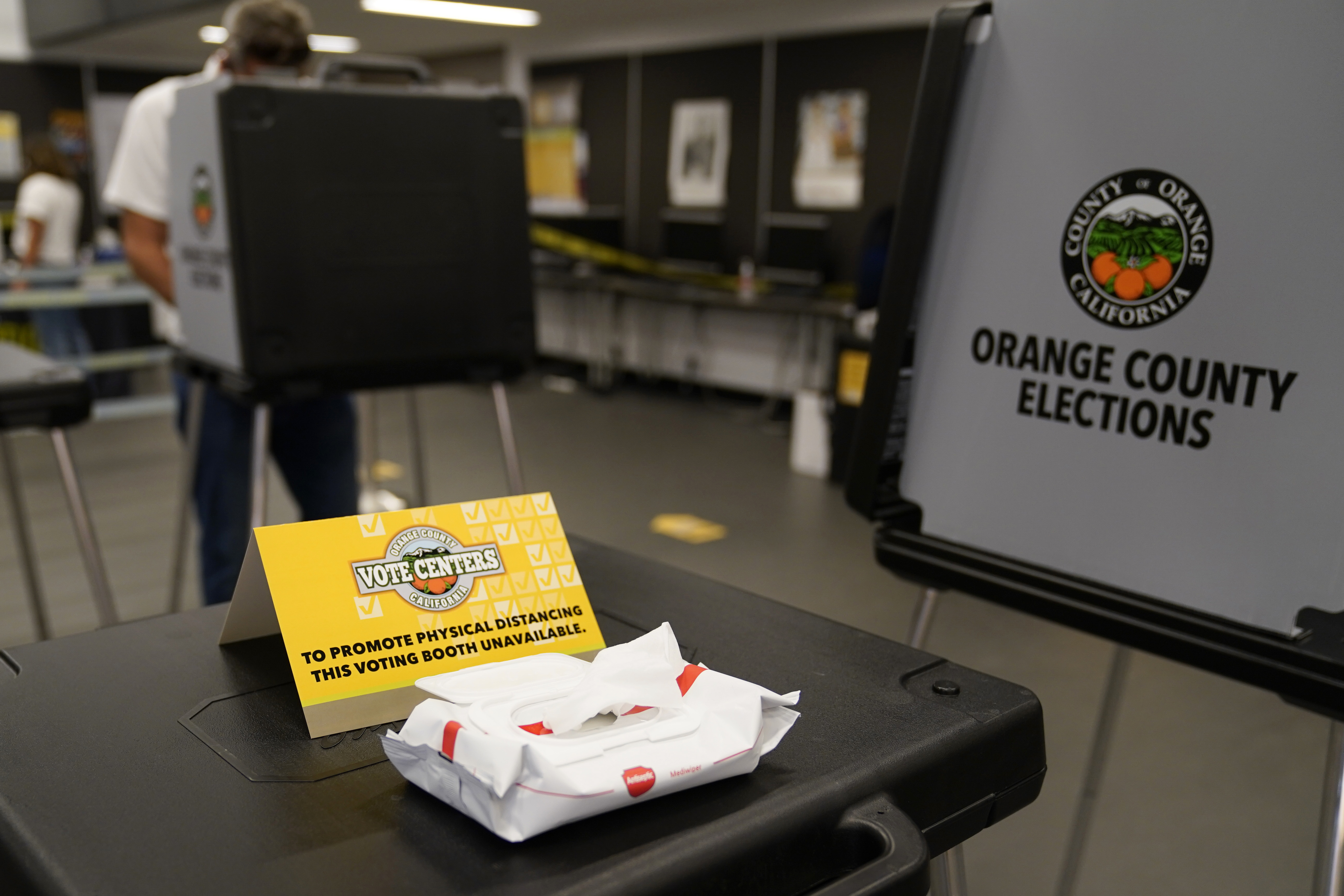 A sign designates physical distancing at a polling place Tuesday, Nov. 3, 2020, in Newport Beach, Calif. (AP Photo/Ashley Landis)