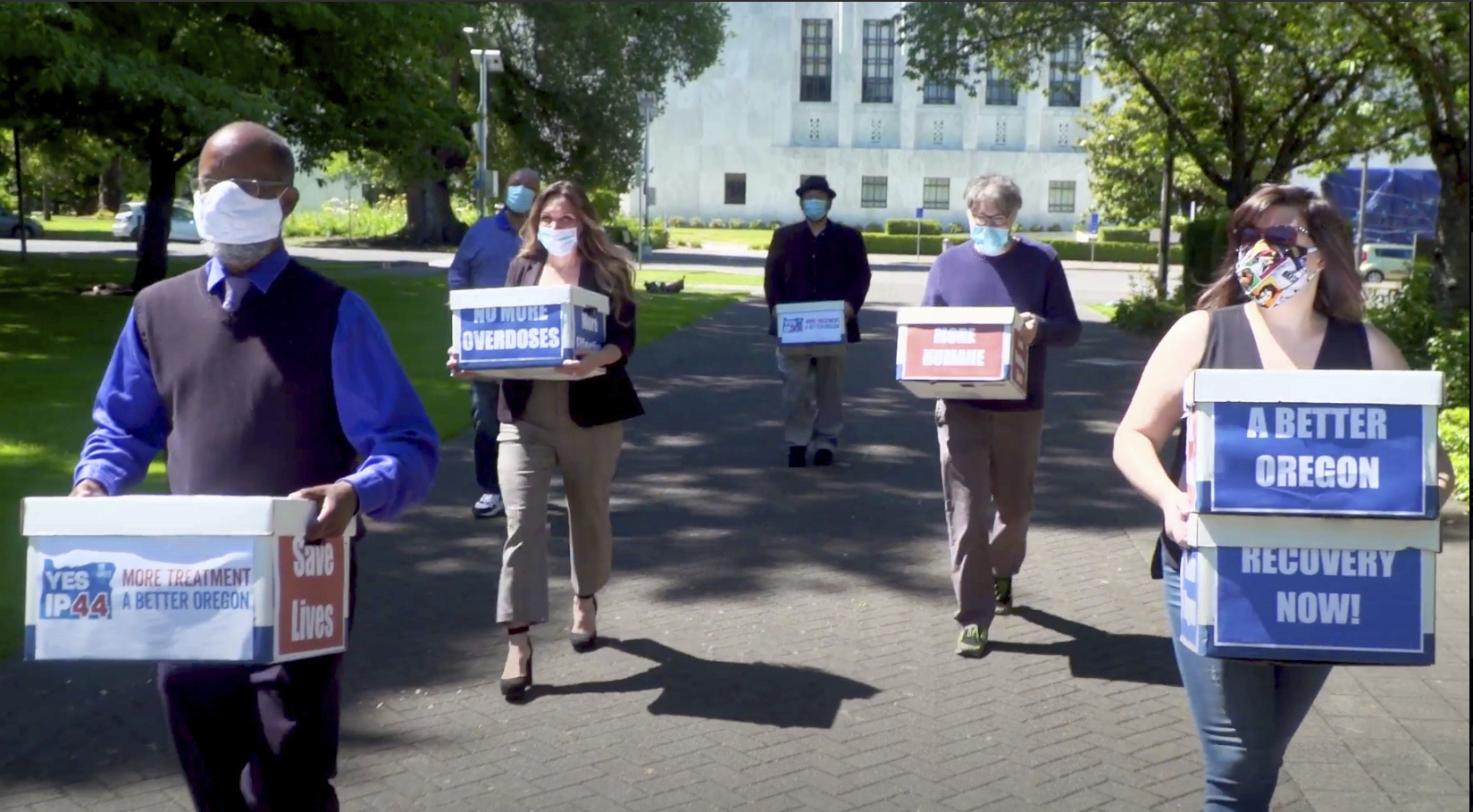 This June 26, 2020 file photo from video provided by the Yes on Measure 110 Campaign shows volunteers delivering boxes containing signed petitions in favor of the measure to the Oregon Secretary of State's office in Salem. The measure said the U.S., possession of small amounts of heroin, cocaine, LSD and other hard drugs would be decriminalized in Oregon. Election returns show the measure passed on Election Day, Tuesday, Nov. 3. (Yes on Measure 110 Campaign via AP, File)