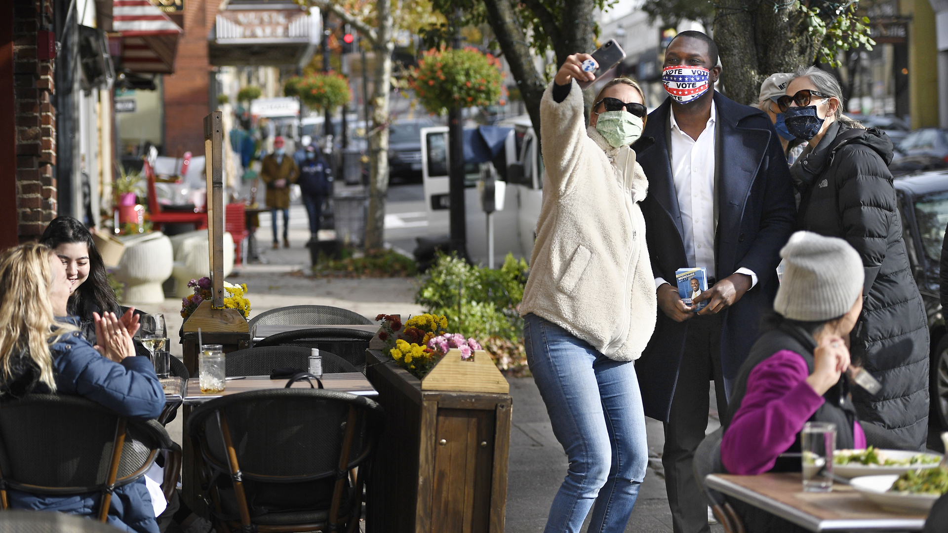 In this Nov. 3, 2020 photo, Democratic candidate Mondaire Jones poses for a selfie while campaigning for the U.S. House of Representatives 17th Congressional seat on Election Day in Tarrytown, N.Y. With the addition of Jones and Ritchie Torres winning in the 2020 election, there will be nine openly LGBTQ members of the House as of January 2021, The seven incumbents all won their races. (Jessica Hill/Associated Press)