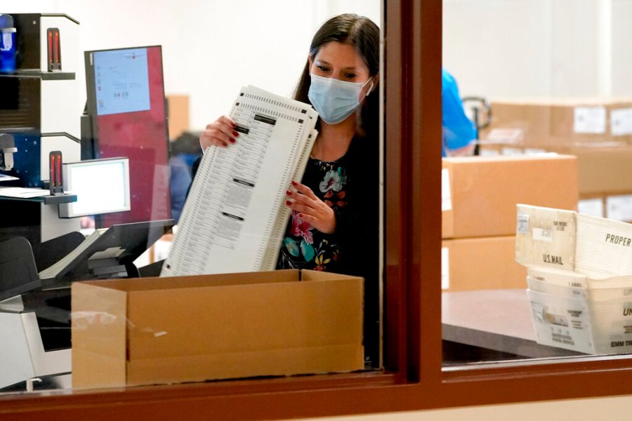 Maricopa County elections officials count ballots, Wednesday, Nov. 4, 2020, at the Maricopa County Recorders Office in Phoenix. (AP Photo/Matt York)