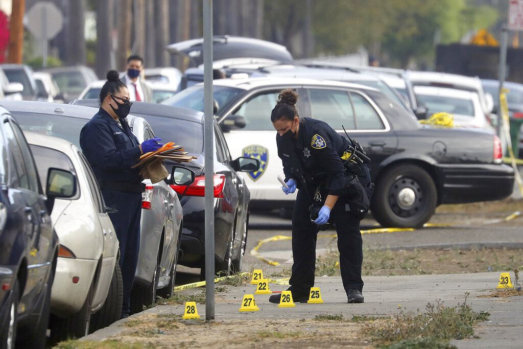 Members of the Oakland Police Department investigate the scene of an officer involved shooting on Wednesday, Nov. 4, 2020, in Oakland, Calif. (Aric Crabb/Bay Area News Group via AP)