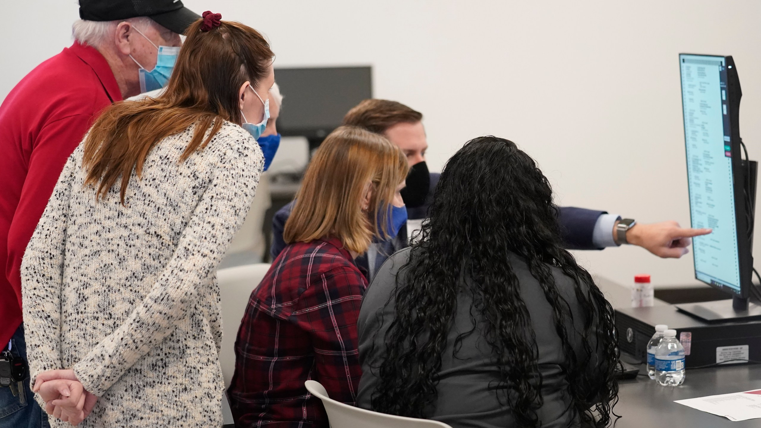 Judges review a ballot at the Gwinnett County Voter Registration and Elections Headquarters, Friday, Nov. 6, 2020, in Lawrenceville, near Atlanta. (AP Photo/John Bazemore)