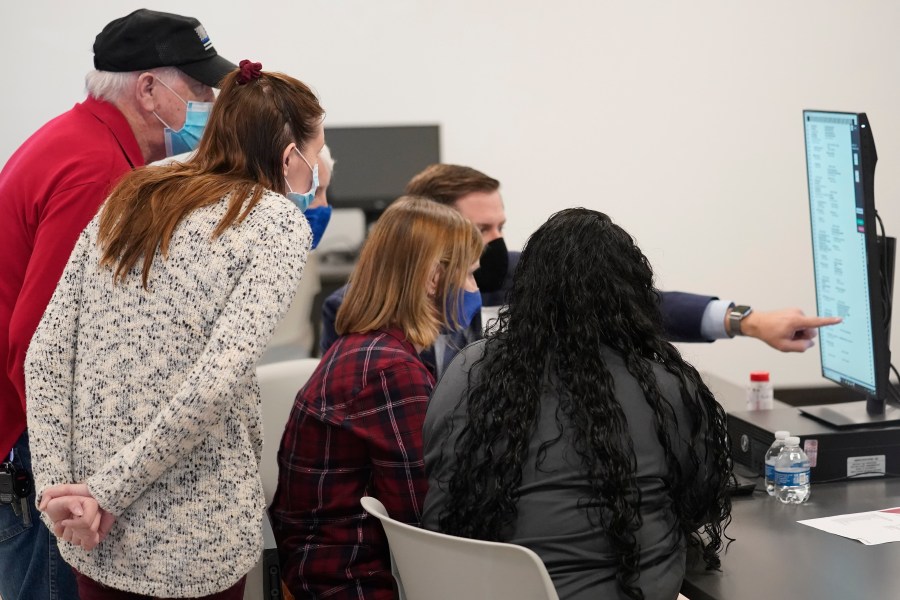 Judges review a ballot at the Gwinnett County Voter Registration and Elections Headquarters, Friday, Nov. 6, 2020, in Lawrenceville, near Atlanta. (AP Photo/John Bazemore)