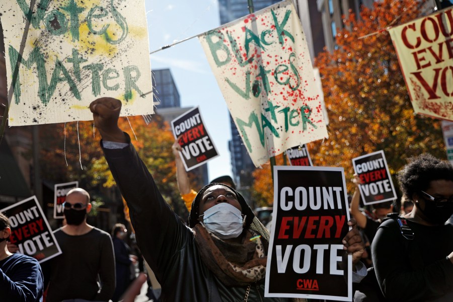 In this Nov. 5, 2020, file photo, Zhanon Morales, 30, of Philadelphia, raises her fist as demonstrators call for all votes be counted during a rally outside the Pennsylvania Convention Center in Philadelphia, as vote counting in the general election continues. (Rebecca Blackwell/AP Photo)