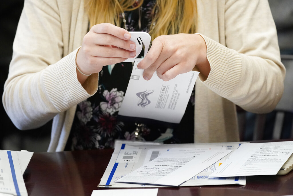 A Luzerne County worker canvases ballots that arrived after closing of voting until Friday at 5 p.m. and postmarked by Nov. 3rd as vote counting in the general election continues, Friday, Nov. 6, 2020, in Wilkes-Barre, Pa. (AP Photo/Mary Altaffer)