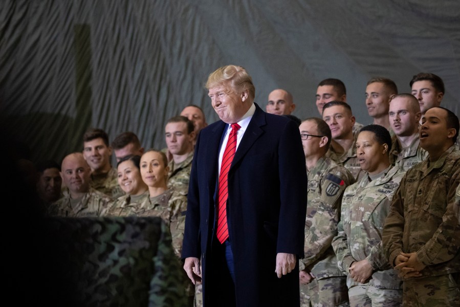 In this Nov. 28, 2019, file photo President Donald Trump smiles before addressing members of the military during a surprise Thanksgiving Day visit at Bagram Air Field, Afghanistan. Trump has held himself up as a champion of U.S. troops without rival. Now, with his presidency on the line, he’s casting suspicion on a tool of participatory democracy, the mail-in ballot, that has allowed U.S. military personnel to participate in elections while serving far from home since the War of 1812. (AP Photo/Alex Brandon, File)