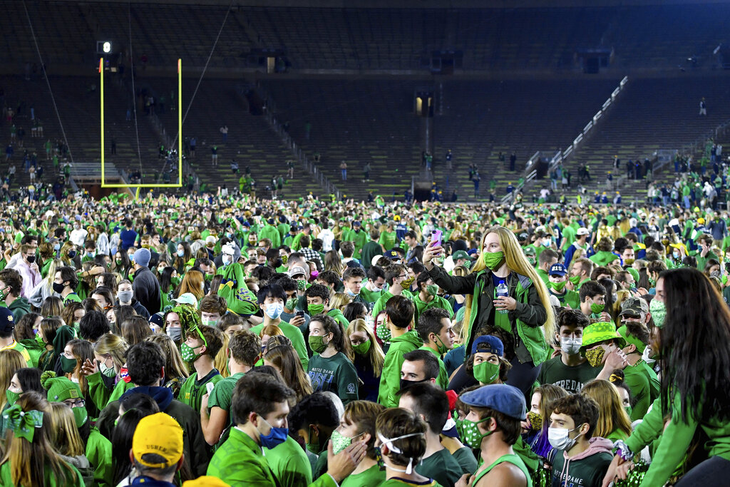 Fans storm the field after Notre Dame defeated the Clemson 47-40 in two overtimes in an NCAA college football game Saturday, Nov. 7, 2020, in South Bend, Ind. (Matt Cashore/Pool Photo via AP)