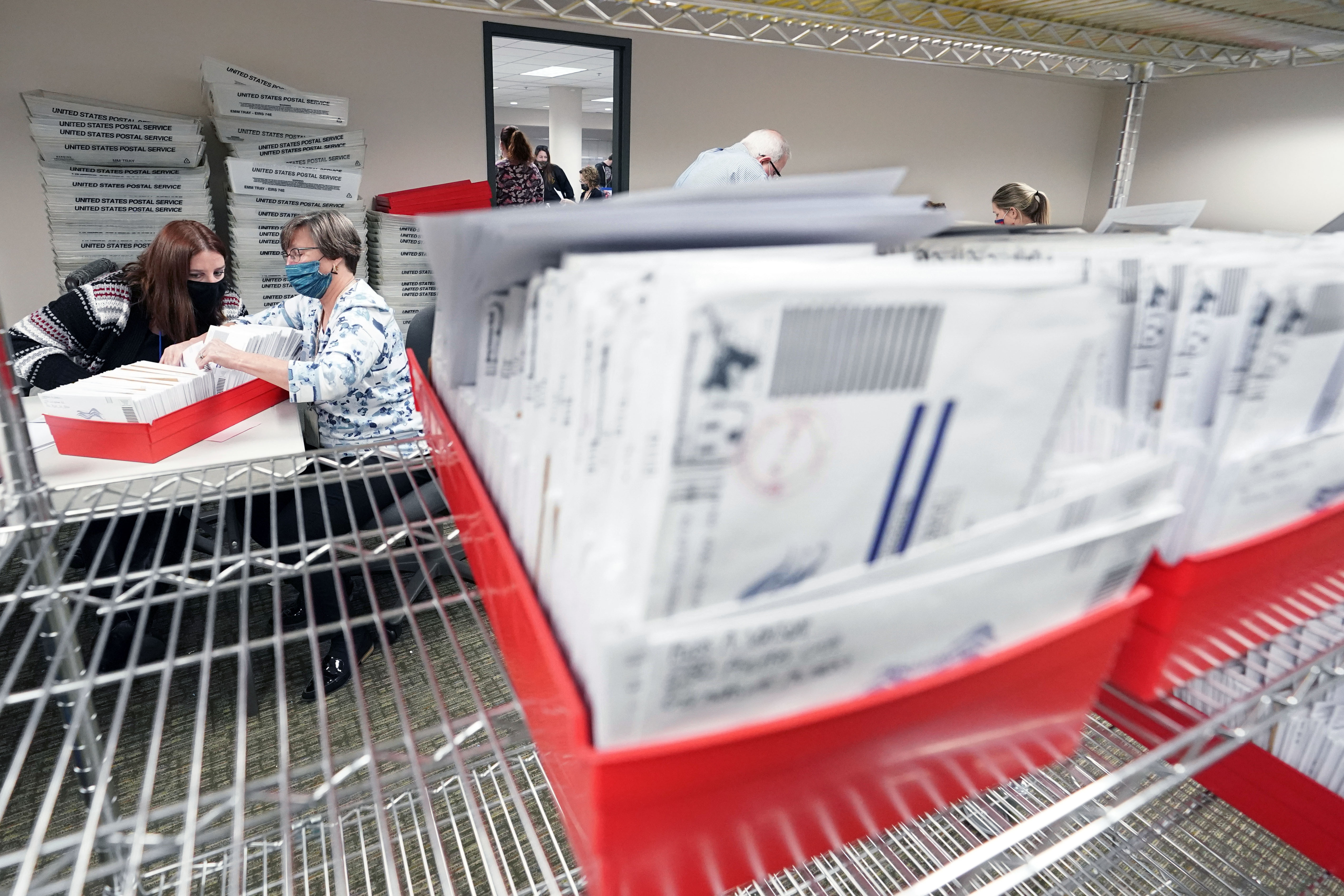 In this Nov. 5, 2020, photo, Lehigh County workers count ballots as vote counting in the general election continues in Allentown, Pa. (AP Photo/Mary Altaffer)