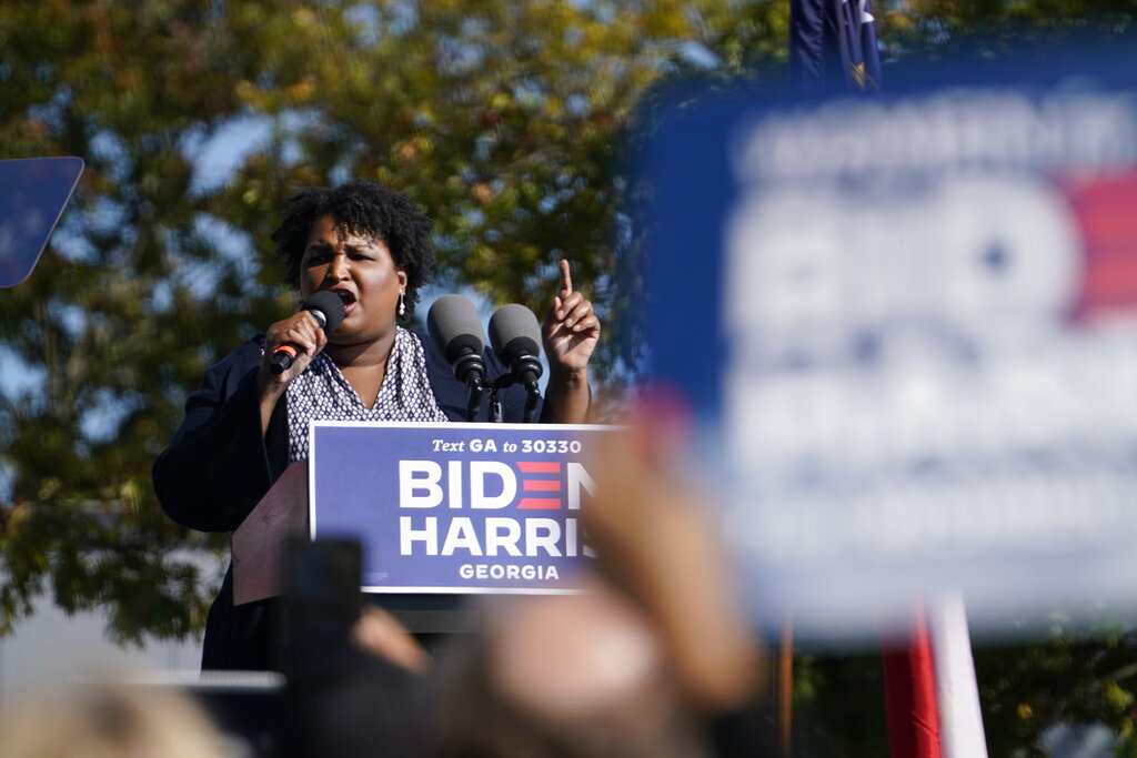 In this Nov. 2, 2020, photo, Stacey Abrams speaks to supporters as they wait for former President Barack Obama to arrive and speak at a rally as he campaigns for Democratic presidential candidate former Vice President Joe Biden, at Turner Field in Atlanta. (AP Photo/Brynn Anderson)