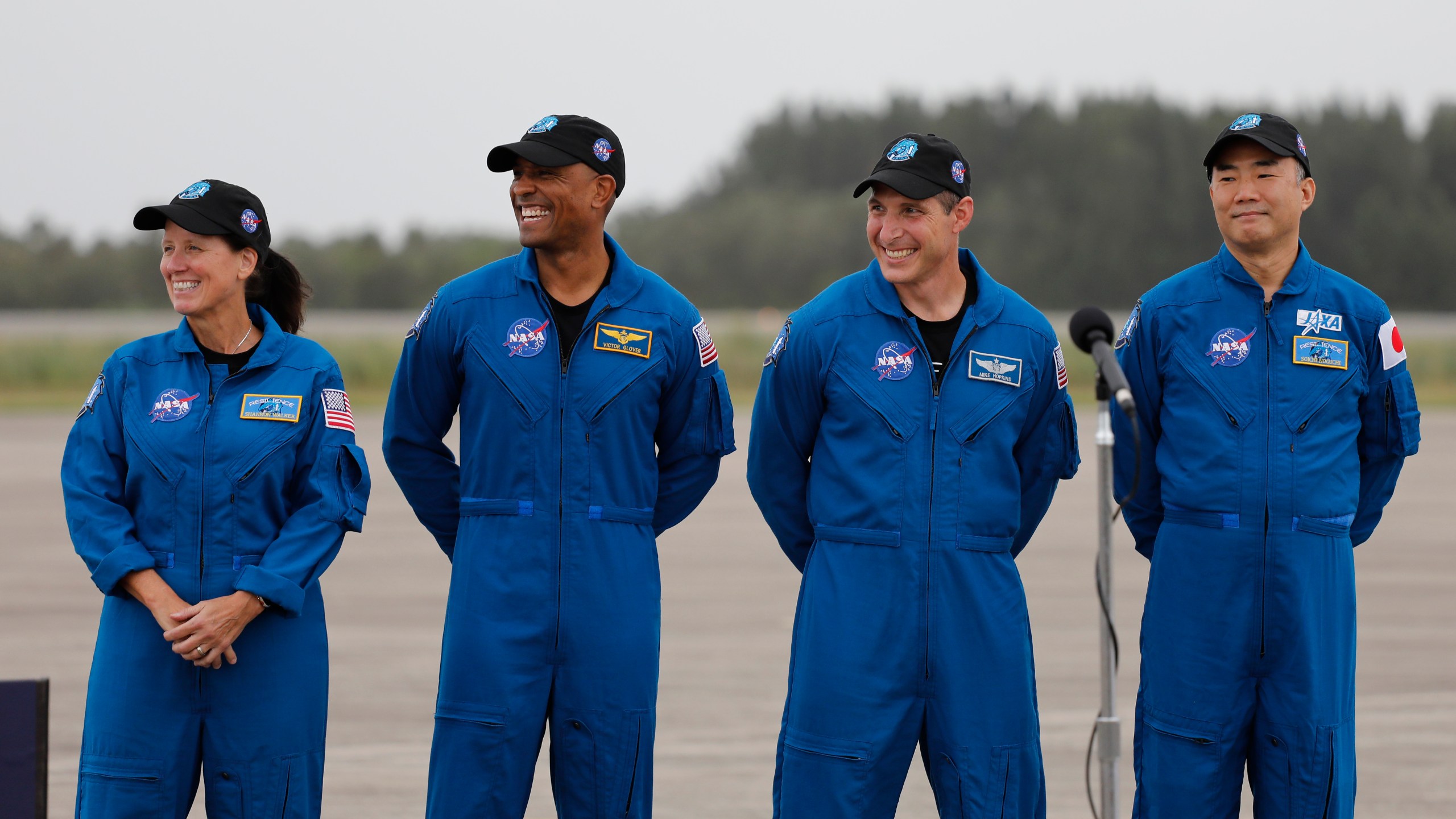 NASA Astronauts from left Shannon Walker, Victor Glover, Michael Hopkins and Japan Aerospace Exploration Agency Astronaut Soichi Noguchi smile during a news conference after they arrived at the Kennedy Space Center, Sunday, Nov. 8, 2020, in Cape Canaveral, Fla. (AP Photo/Terry Renna)