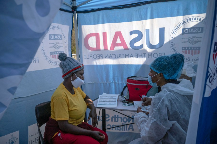 In this July 2, 2020 file photo, nurse Nomautanda Siduna, right, talks to a patient who is HIV-positive inside a gazebo used as a mobile clinic in Ngodwana, South Africa. Researchers are stopping a study early after finding that a shot of an experimental medicine every two months worked better than daily Truvada pills to help keep uninfected women from catching HIV from an infected sex partner. The news is a boon for AIDS prevention efforts especially in Africa, where the study took place, and where women have few discreet ways of protecting themselves from infection. (AP Photo/Bram Janssen, File)