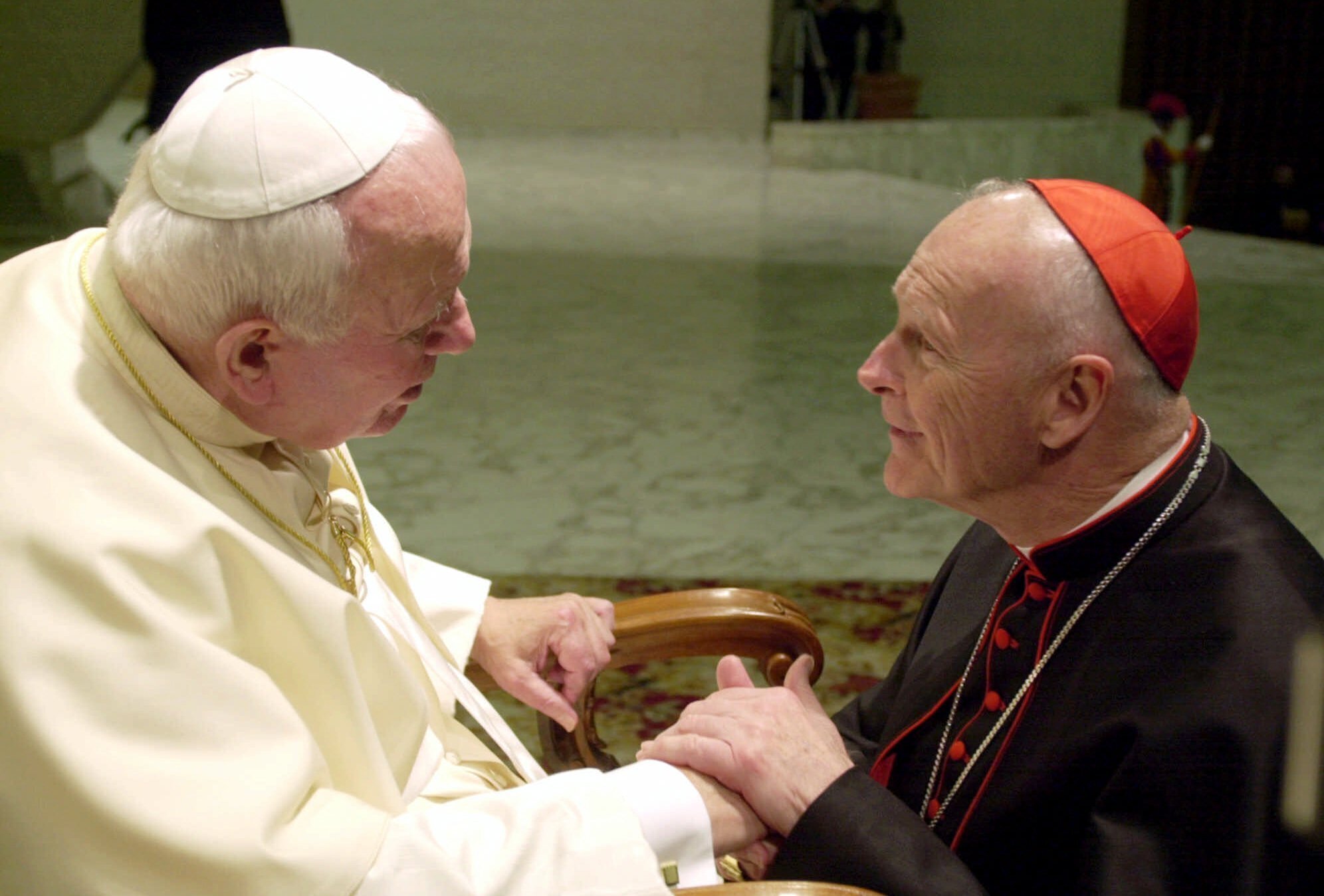 In this Feb. 23, 2001 file photo, U.S. Cardinal Theodore Edgar McCarrick, archbishop of Washington, D.C., shakes hands with Pope John Paul II during the General Audience with the newly appointed cardinals in the Paul VI hall at the Vatican. (Massimo Sambucetti/Associated Press)