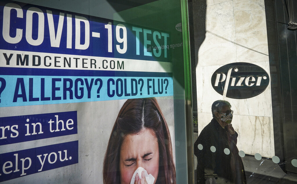 A bus stop ad for COVID-19 testing is shown outside Pfizer world headquarters in New York on Nov. 9, 2020.(AP Photo/Bebeto Matthews)