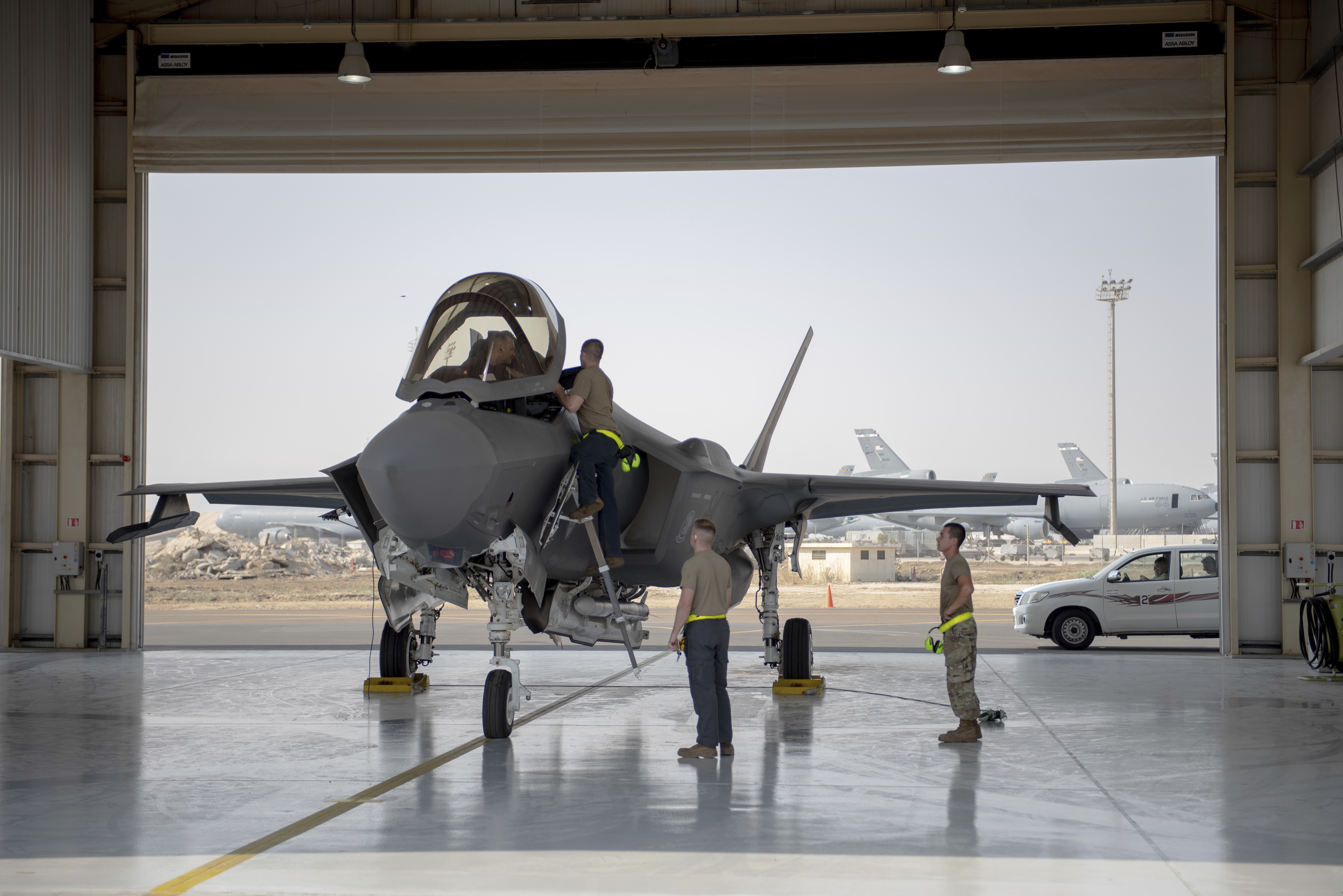 In this Aug. 5, 2019, photo released by the U.S. Air Force, an F-35 fighter jet pilot and crew prepare for a mission at Al-Dhafra Air Base in the United Arab Emirates. (Staff Sgt. Chris Thornbury/U.S. Air Force via AP)