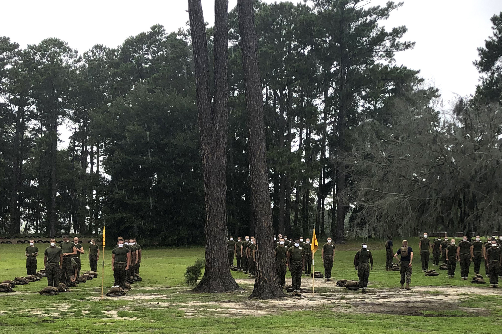 In this May 27, 2020, photo, Marine recruits line up at Parris Island Recruit Depot, S.C. A study published on Nov. 11, 2020, found that despite temperature and COVID-19 symptom checks and strict quarantines before they were allowed to start training, new Marine recruits spread the virus to others even though hardly any of them had symptoms. None of the infections that occurred were caught through symptom screening. (Lolita Baldor / Associated Press)