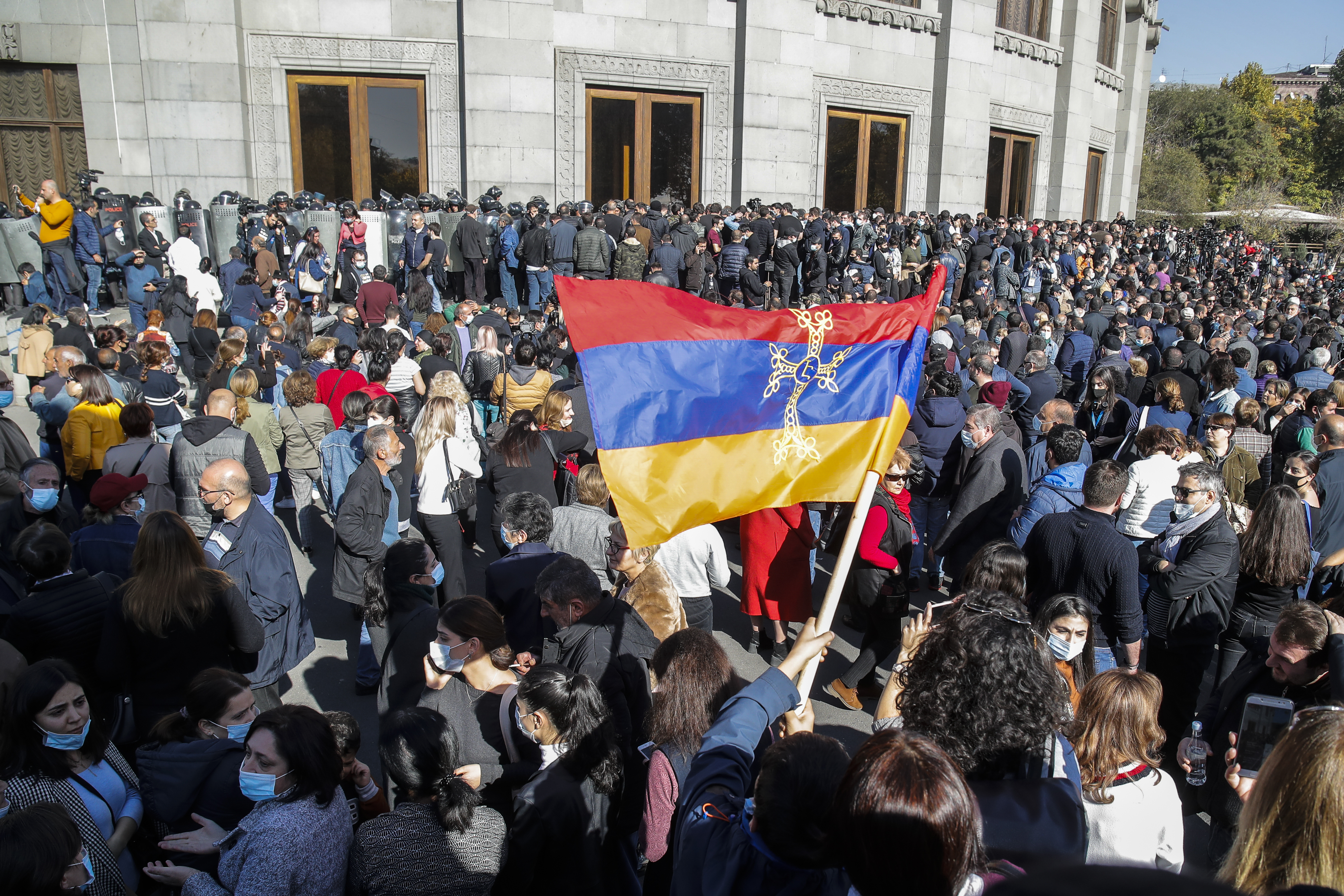 Protesters wave an Armenian national flag during a protest against an agreement to halt fighting over the Nagorno-Karabakh region, in Yerevan, Armenia, Wednesday, Nov. 11, 2020. (AP Photo/Dmitri Lovetsky)