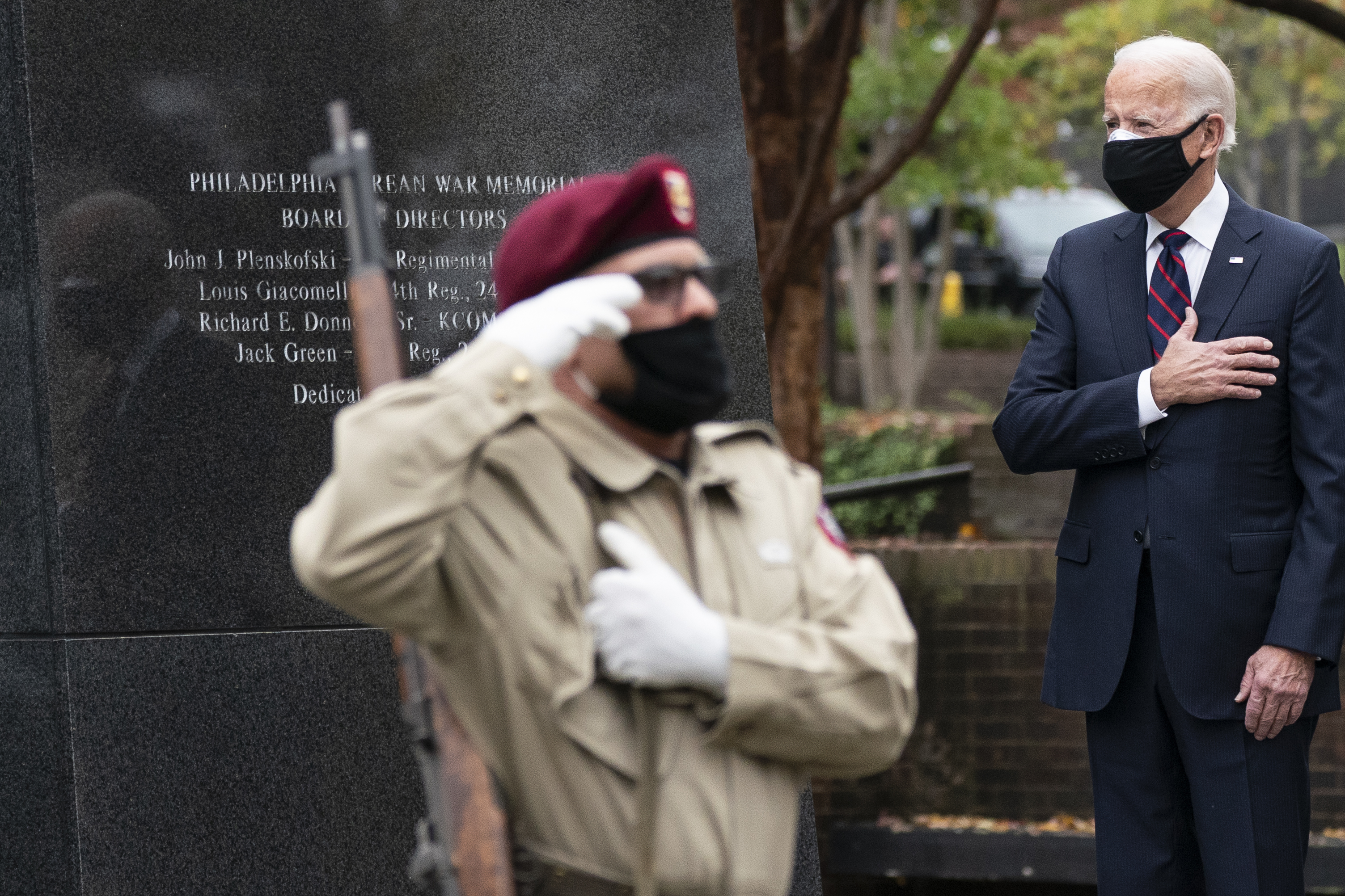 President-elect Joe Biden stands with his hand over his heart, after placing a wreath at the Philadelphia Korean War Memorial at Penn's Landing, on Veterans Day, Nov. 11, 2020, in Philadelphia. (Alex Brandon/Associated Press)