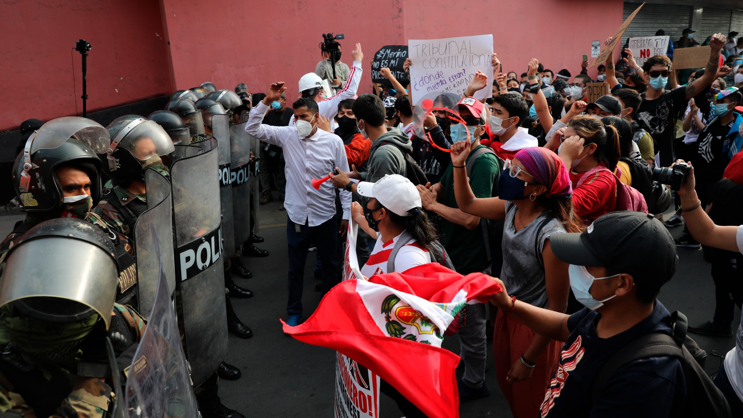 Supporters of ousted President Martin Vizcarra shout at police to let them pass as they try to march to Congress in Lima, Peru, Wednesday, Nov. 11, 2020. (Rodrigo Abd/AP Photo)