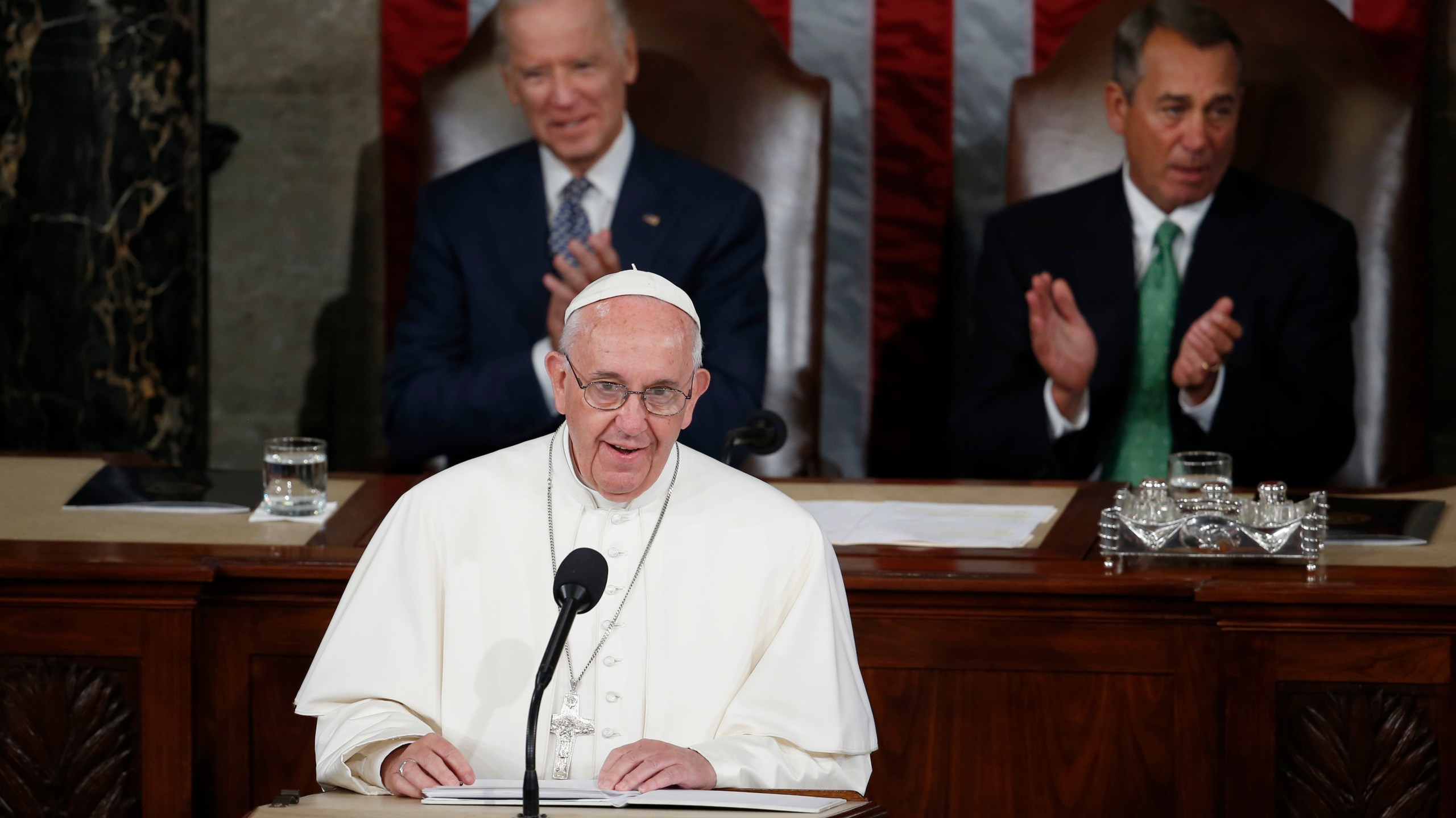 In this Sept. 24, 2015, file photo, Pope Francis addresses a joint meeting of Congress on Capitol Hill, making history as the first pontiff to do so. Listening behind the pope are Vice President Joe Biden and House Speaker John Boehner of Ohio. (Carolyn Kaster / Associated Press)