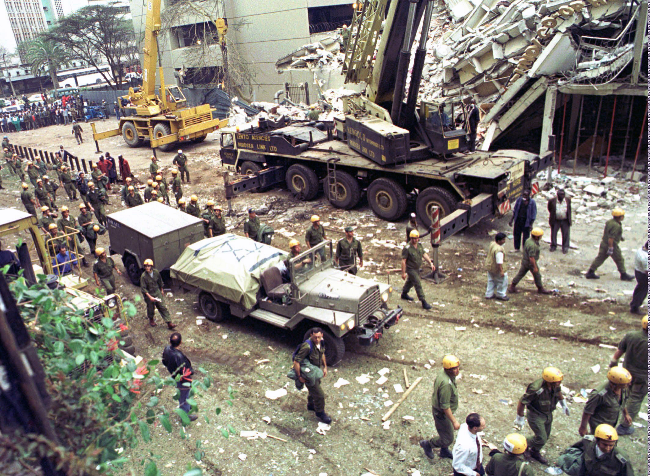 In this Sunday, Aug. 9, 1998 file photo, Israeli soldiers bring in heavy lifting equipment to the wreckage of the Ufundi House, adjacent to the U.S. embassy in Nairobi. (Sayyid Azim/AP Photo)