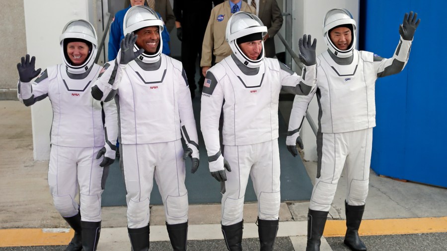 NASA astronauts, from left, Shannon Walker, Victor Glover, and Michael Hopkins and Japan Aerospace Exploration Agency astronaut Soichi Noguchi leave the Operations and Checkout Building on their way to launch pad 39A for the SpaceX Crew-1 mission to the International Space Station at the Kennedy Space Center in Cape Canaveral, Fla., on Nov. 15, 2020. (John Raoux / Associated Press)