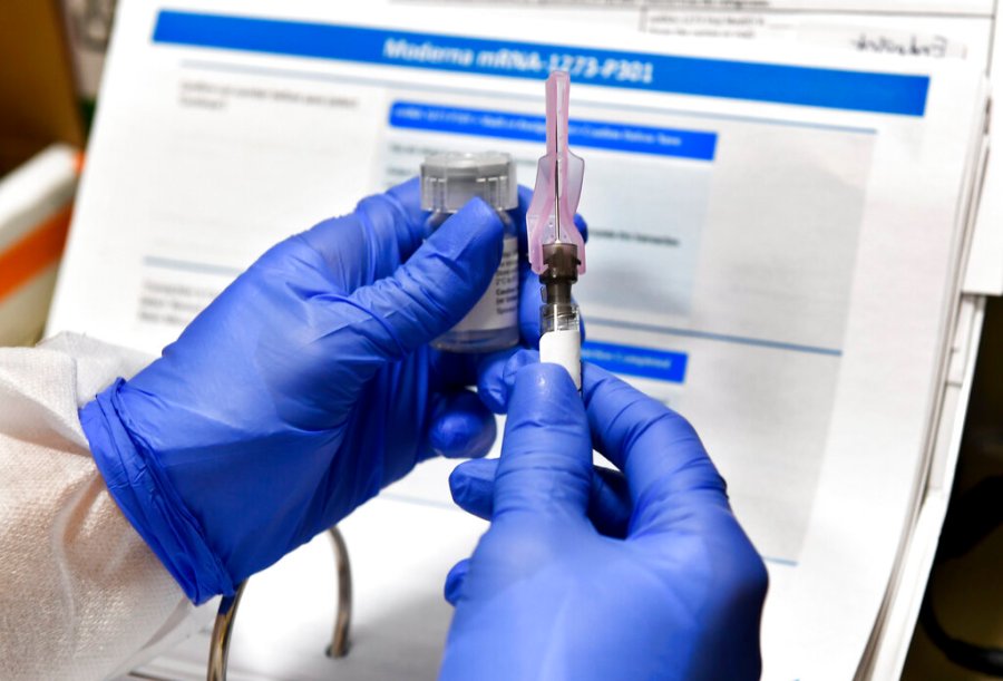 In this July 27, 2020, file photo, nurse Kathe Olmstead prepares a shot that is part of a possible COVID-19 vaccine, developed by the National Institutes of Health and Moderna Inc., in Binghamton, N.Y. (AP Photo/Hans Pennink, File)