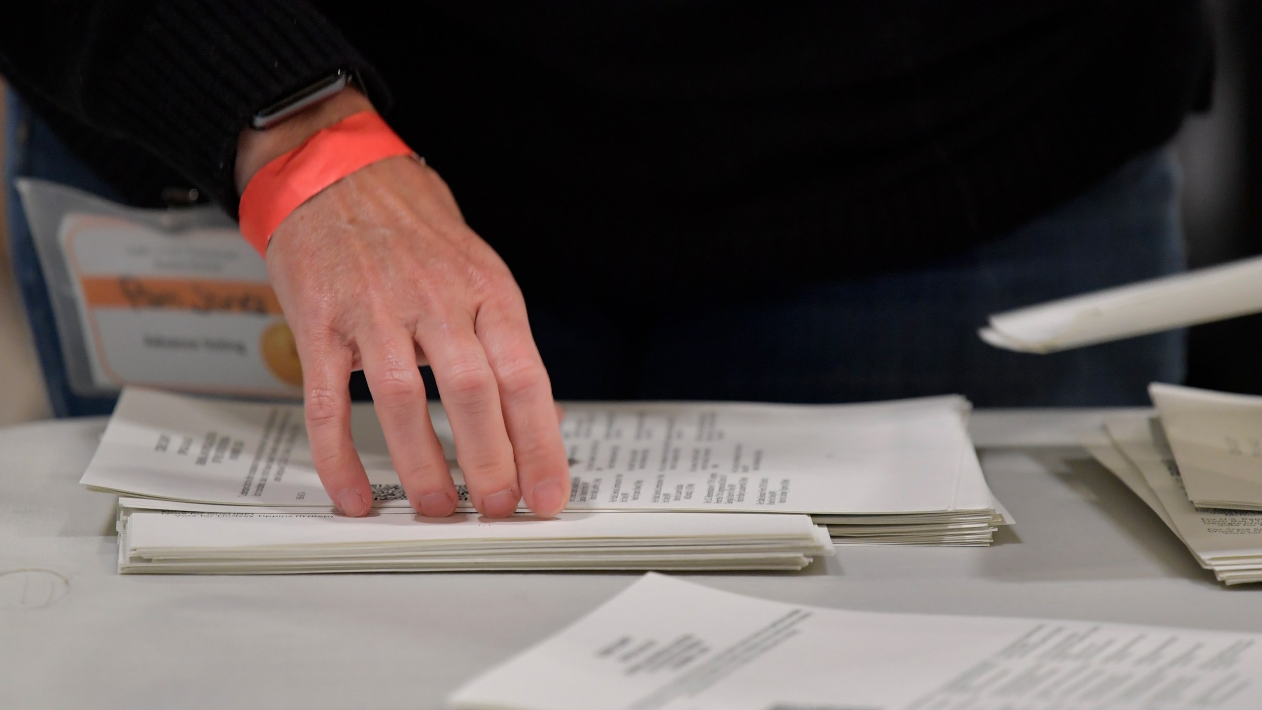 Cobb County Election officials handle ballots during an audit, Monday, Nov. 16, 2020, in Marietta, Ga. A hand tally of the nearly 5 million votes cast in the presidential race in Georgia has entered its fourth day Monday. (AP Photo/Mike Stewart)