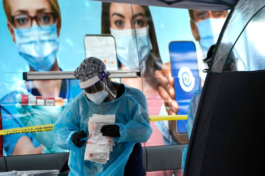 A health care employee works at a walk-up COVID-19 testing site in Miami on Nov. 18, 2020. (Lynne Sladky/Associated Press)