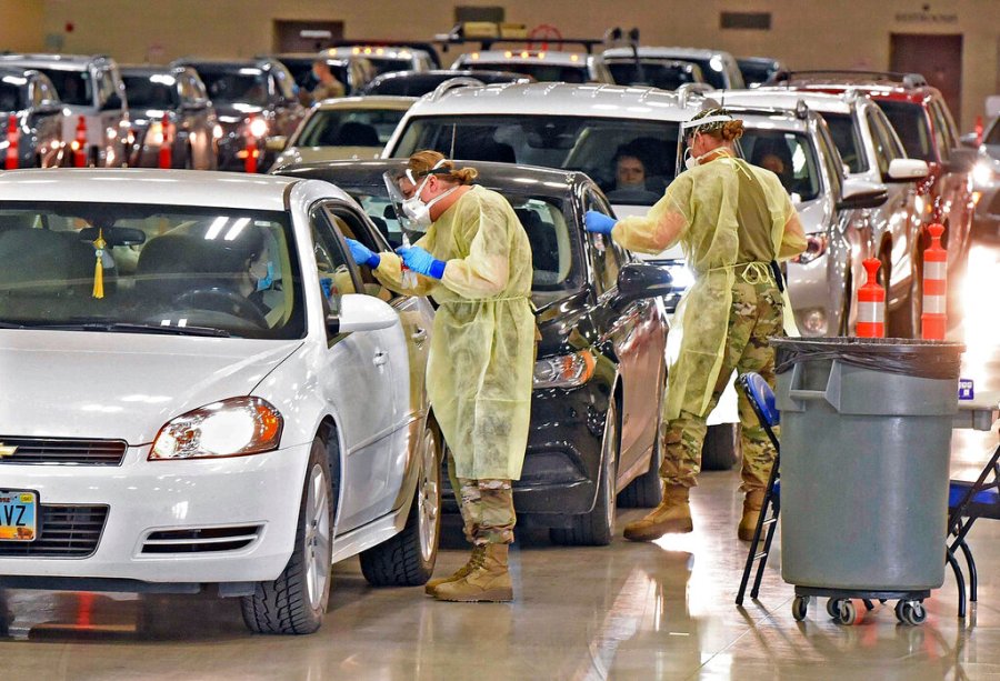 In this Nov. 17, 2020, file photo, North Dakota National Guard soldiers administer coronavirus tests inside the Bismarck Events Center in Bismarck, N.D. (Tom Stromme/The Bismarck Tribune via AP, File)