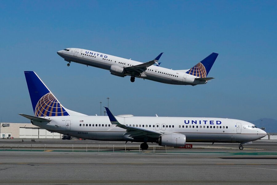 In this Oct. 15, 2020, file photo, a United Airlines airplane takes off over a plane on the runway at San Francisco International Airport. (Jeff Chiu/AP Photo)