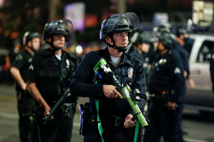 Police officers stand guard as they clear the streets during a protest in Los Angeles following the presidential election on Nov. 4, 2020. (Ringo H.W. Chiu / Associated Press)