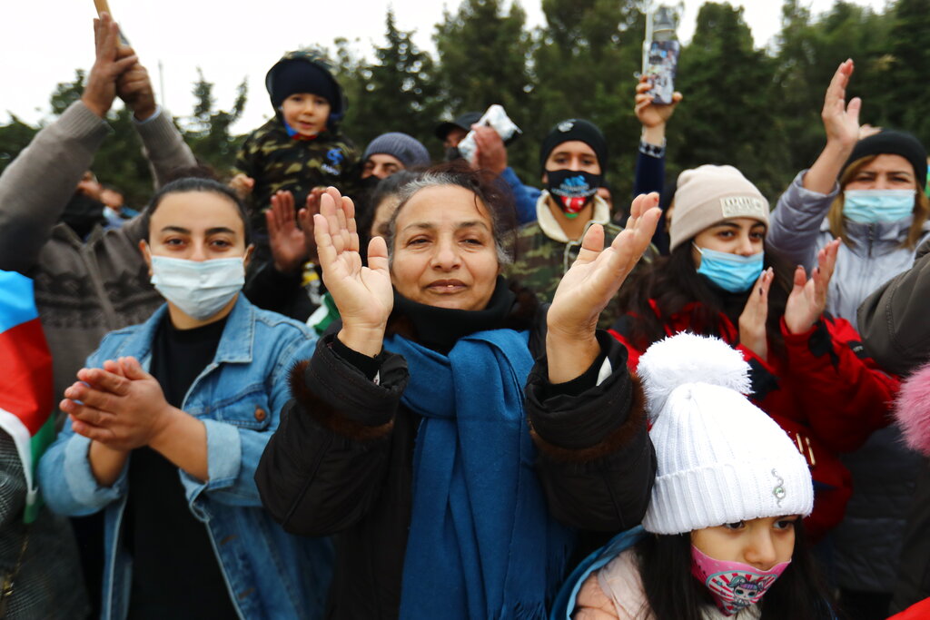 Azerbaijanis celebrate entry of troops in Nagorno-Karabakh's Aghdam region in Baku, Azerbaijan, Friday, Nov. 20, 2020. (AP Photo/Aziz Karimov)