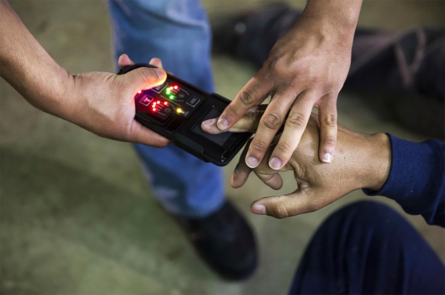 This undated photo obtained from Immigration and Customs Enforcement (ICE) shows a NeoScan 45 fingerprint scanner. The device, paired with an app known as EDDIE, is used by ICE to run remote ID checks.(Immigration and Customs Enforcement via AP)