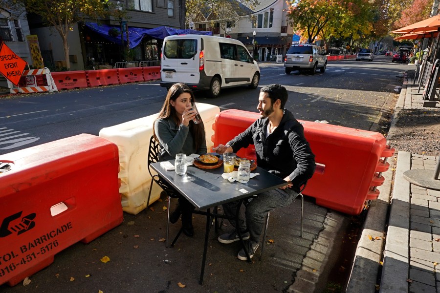 Ranim Abaad and Joey Bettencourt, right, have lunch at the RIND in Sacramento on Nov. 20, 2020. (Rich Pedroncelli / Associated Press)