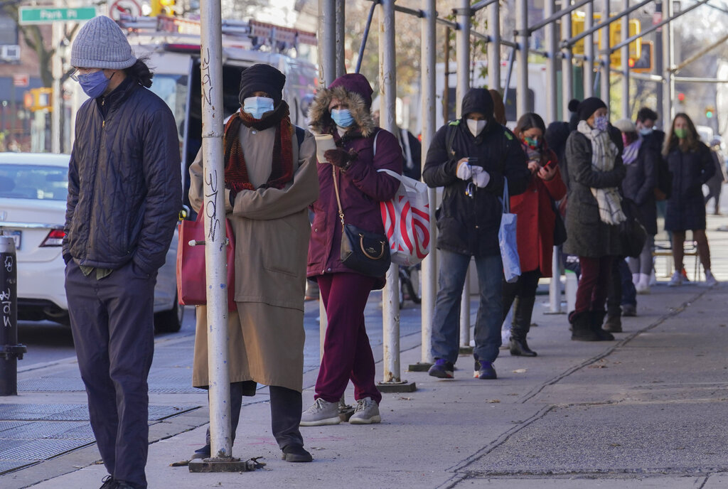 People wait on a line stretching around a block for a clinic offering COVID-19 testing on Nov. 18, 2020, in the Park Slope area of the Brooklyn borough of New York. (AP Photo/Bebeto Matthews)