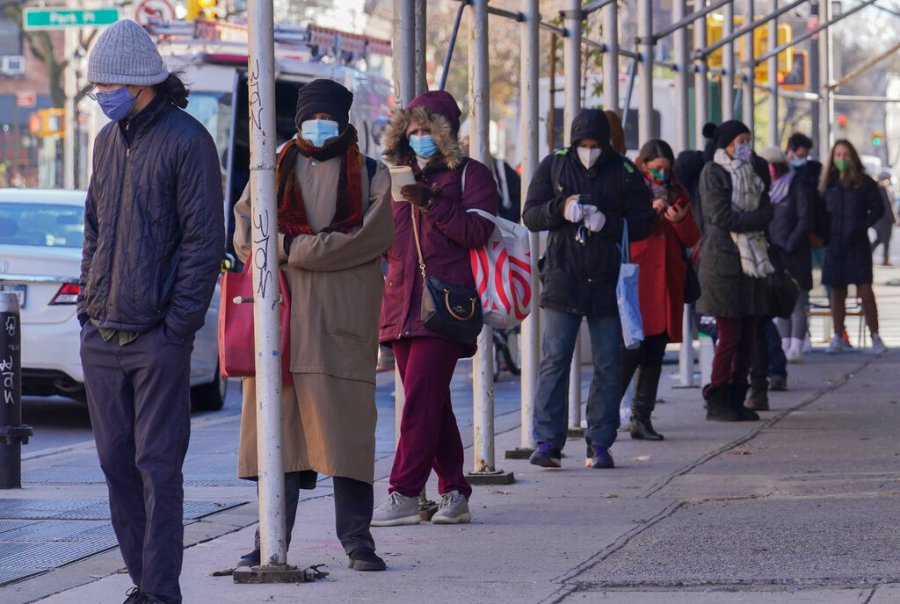 People wait on a line stretching around a block for a clinic offering COVID-19 testing on Nov. 18, 2020, in the Park Slope area of the Brooklyn borough of New York. (AP Photo/Bebeto Matthews)