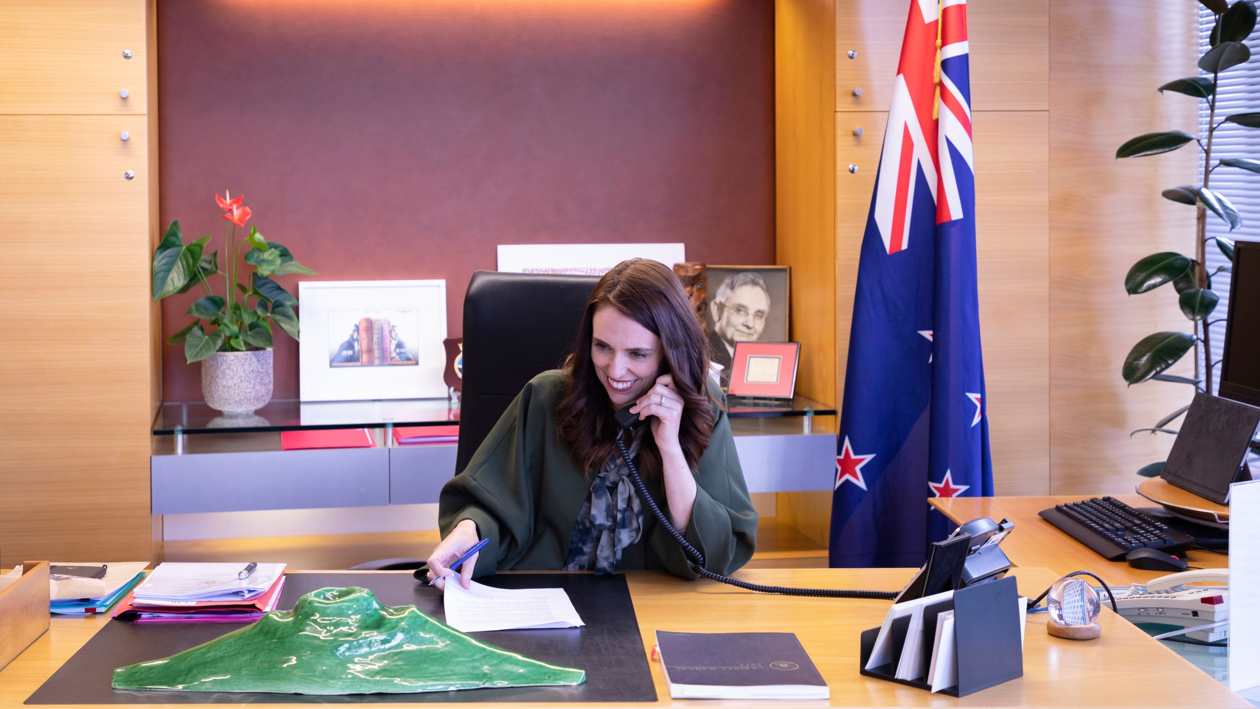 In this photo provided by New Zealand Prime Minister's Office, Prime Minister Jacinda Ardern talks with U.S. President-elect Joe Biden on phone at her office in Wellington, New Zealand, Monday, Nov. 23, 2020. (New Zealand Prime Minister's Office via AP)