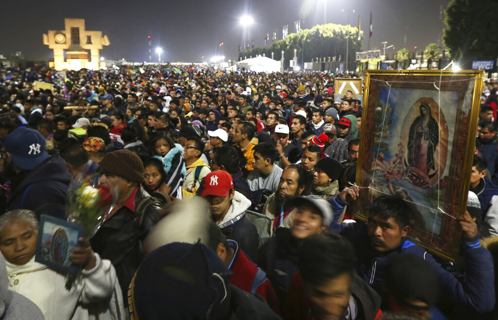 In this Dec. 12, 2019 file photo, pilgrims arrive at the plaza outside the Basilica of Our Lady of Guadalupe in Mexico City. (AP Photo/Marco Ugarte, File)