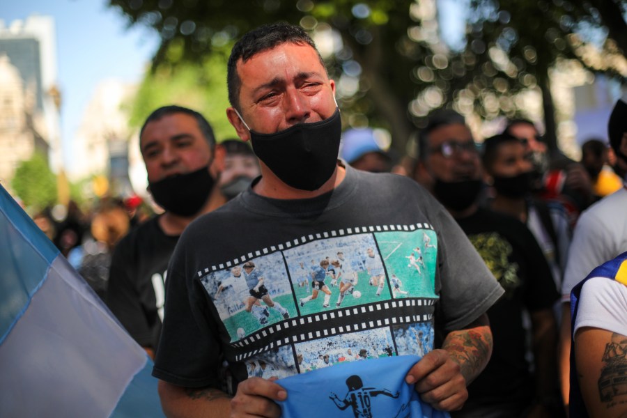 A man cries as he waits in a line outside the presidential palace in Buenos Aires to pay his final respects to Diego Maradona on Nov. 26, 2020. (Rodrigo Abd / Associated Press)