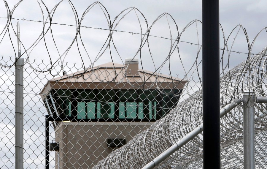 This June 25, 2013 file photo shows a guard tower over the fence surrounding the new California Correctional Health Care Facility in Stockton, Calif. (AP Photo/Rich Pedroncelli,File)