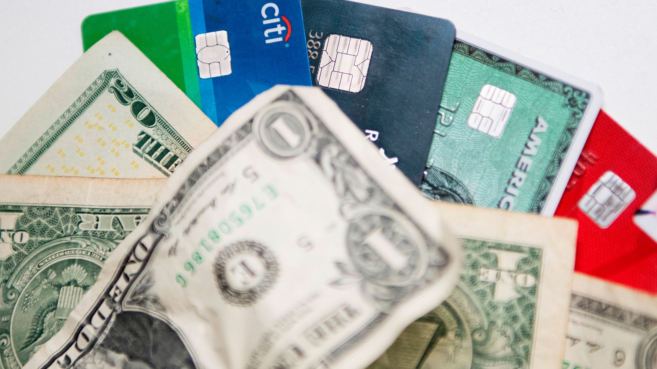 In this illustration, paper currency and plastic bankcards are pictured in Washington, DC, on October 24, 2018. (Jim Watson/AFP via Getty Images)