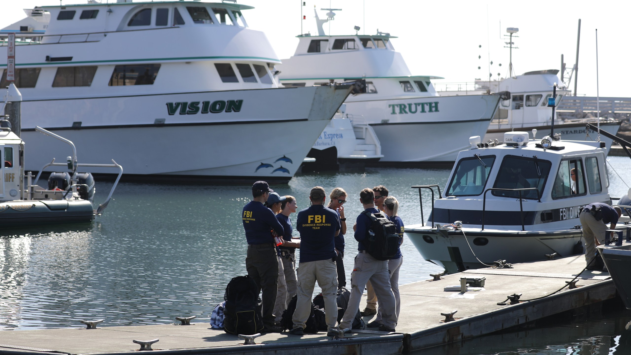 FBI personnel stand on a jetty in front of the ships Vision (L) and Truth, sister vessels of the diving ship Conception, in Santa Barbara Harbor on September 4, 2019 in Santa Barbara, California. (Mario Tama/Getty Images)