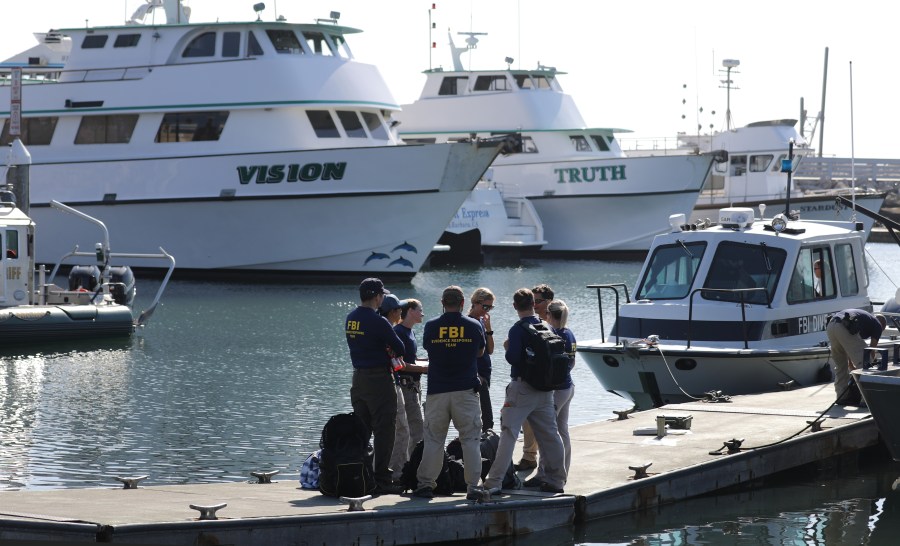 FBI personnel stand on a jetty in front of the ships Vision (L) and Truth, sister vessels of the diving ship Conception, in Santa Barbara Harbor on September 4, 2019 in Santa Barbara, California. (Mario Tama/Getty Images)