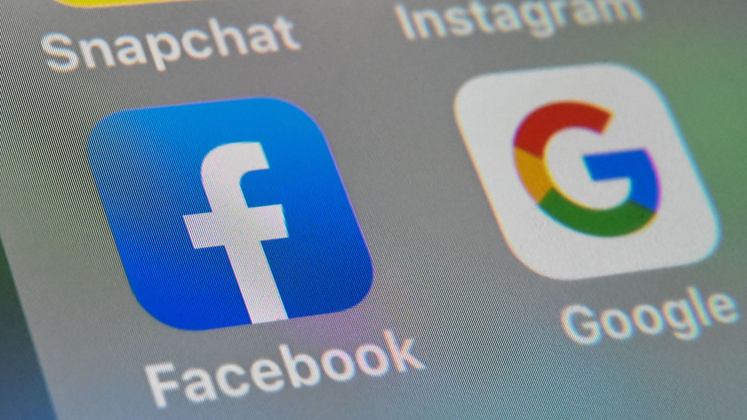 A picture taken on October 1, 2019 in Lille shows the logos of mobile apps Facebook and Google displayed on a tablet. (Denis Charlet/ AFP via Getty Images)