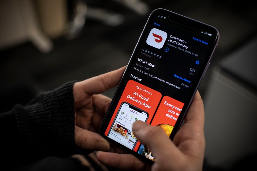 An AFP journalist checks the DoorDash food delivery application on her smartphone on Feb. 27, 2020, in Washington, D.C. (ERIC BARADAT/AFP via Getty Images)