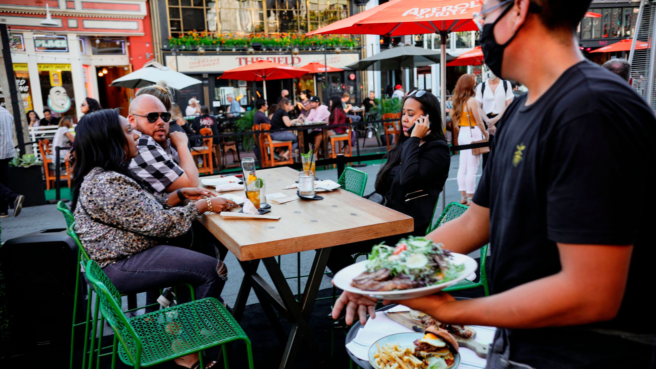 Patrons dine at an outdoor restaurant along 5th Avenue in The Gaslamp Quarter in downtown San Diego, California on, July 17, 2020. (Sandy Huffaker/AFP via Getty Images)