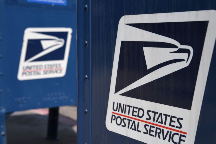 The United States Postal Service logo is seen on a mailbox outside a post office in Los Angeles on Aug. 17, 2020. (Robyn Beck / AFP / Getty Images)