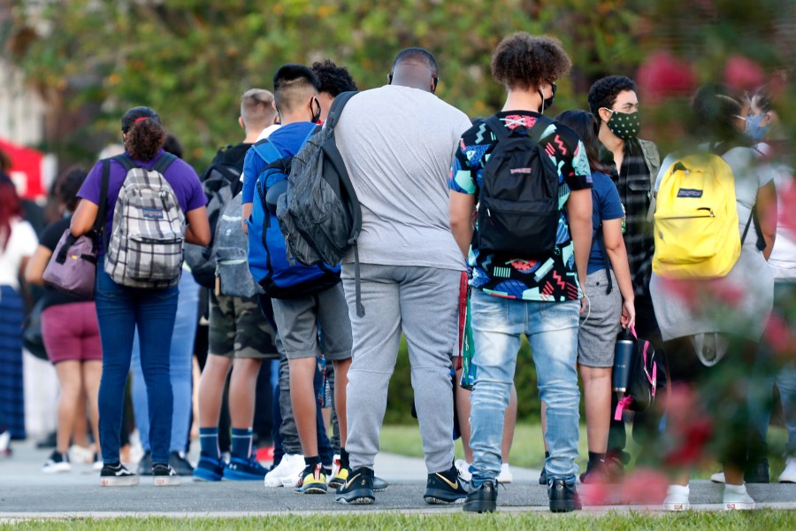 Students at Hillsborough High School in Tampa wait in line to have their temperature checked before entering the building on Aug. 31, 2020. (Octavio Jones / Getty Images)