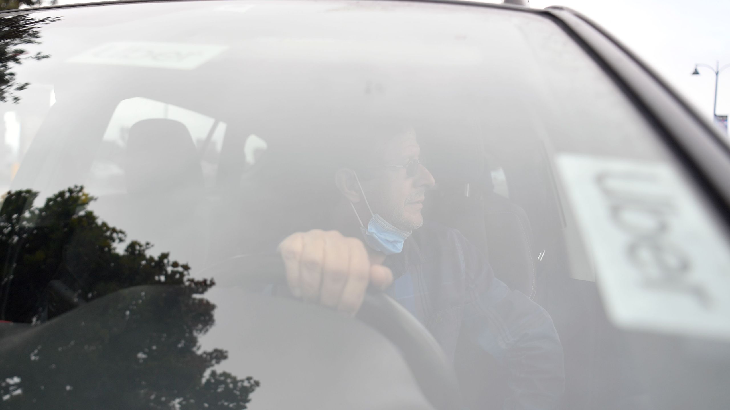 An Uber driver speaks to a reporter about why he supports a no on Proposition 22 vote in Oakland on Oct. 9, 2020. (Josh Edelson / AFP / Getty Images)