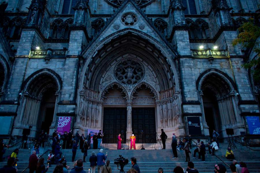 People attend a candlelight vigil a procession in tribute to all of the lives affected by the novel coronavirus outside The Cathedral of St. John the Divine in New York City on Oct. 19, 2020. (Kena Betancur / AFP / Getty Images)